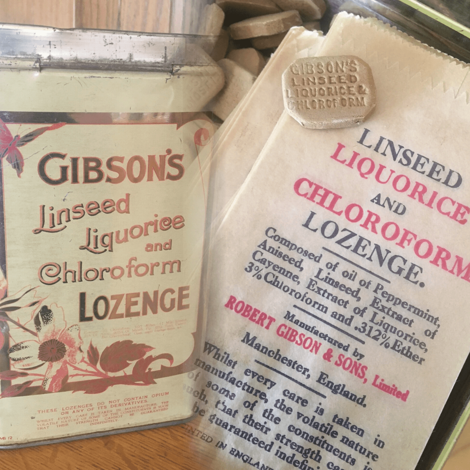 tin of lozenges and lozenge resting on paper packaging