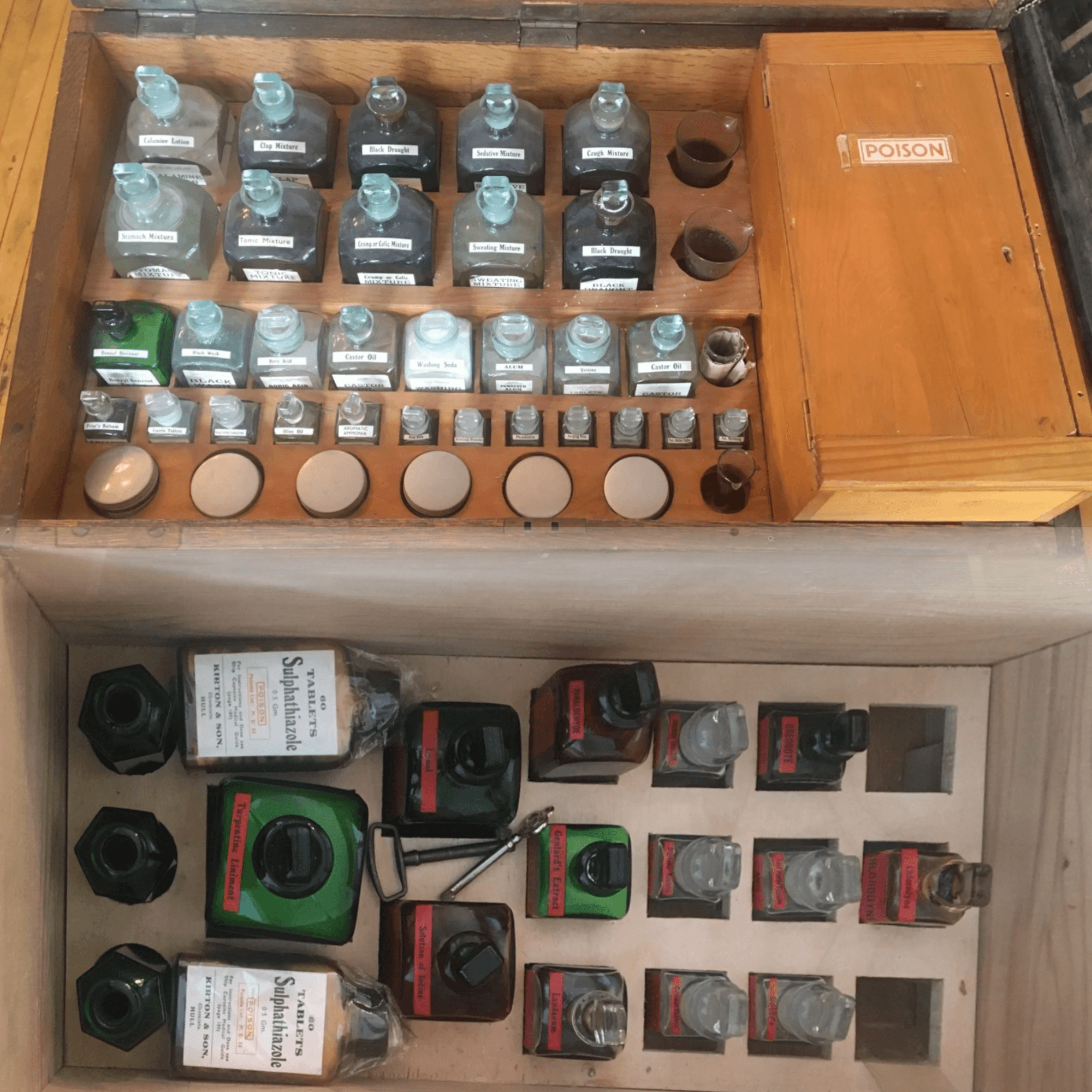 Wooden chest containing many glass bottles of medicines
